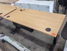 145 · 2 X ELECTRIC HEIGHT ADJUSTABLE DESKS. BEECH WOODGRAIN LAMINATE TOPS, BLACK LEGS. 1,500 X 700 MM. (ONE DESK INCOMPLETE, MISSING CONTROL BOX) NO GST