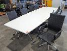 150 · 10-SEAT BOAT SHAPED CONFERENCE TABLE. WHITE LAMINATE TOP IN TWO SECTIONS. POLISHED STEEL BASE. 3,000 X 2,000 X 730 MM (W D H OVERALL). WITH 8 X REPLICA EAMES DESIGN MEETING CHAIRS NO GST