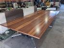 173 · SUBSTANTIAL BOARDROOM TABLE. RED-BROWN POLISHED WOODGRAIN LAMINATE TABLE TOP. MATT BLACK & POLISHED STEEL FRAME. 3-PANEL CONSTRUCTION. 4,800 X 1,800 X 720 MM (W D H)