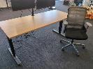 7 · ELECTRIC HEIGHT ADJUSTABLE OFFICE DESK. OAK WOODGRAIN LAMINATE TOP ON BLACK STEEL FRAME. 1,800 X 750 MM., WITH SPINELLY MESH BACK GAS LIFT OFFICE CHAIR.