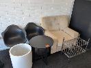 17 · OFFICE FURNITURE. INCLUDES LARGE FABRIC ARM CHAIR IN WHEAT, 2 X REPLICA EAMES DAW SHELL CHAIRS IN BLACK, WHITE PLANTER POT, ROUND TABLE WITH UNDERSHELF IN BLACK AND SMALL METRO STYLE SHELF UNIT.