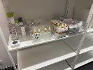 SHELF LOT OF ASSORTED EYE LASHES & BOTTLES, ETC